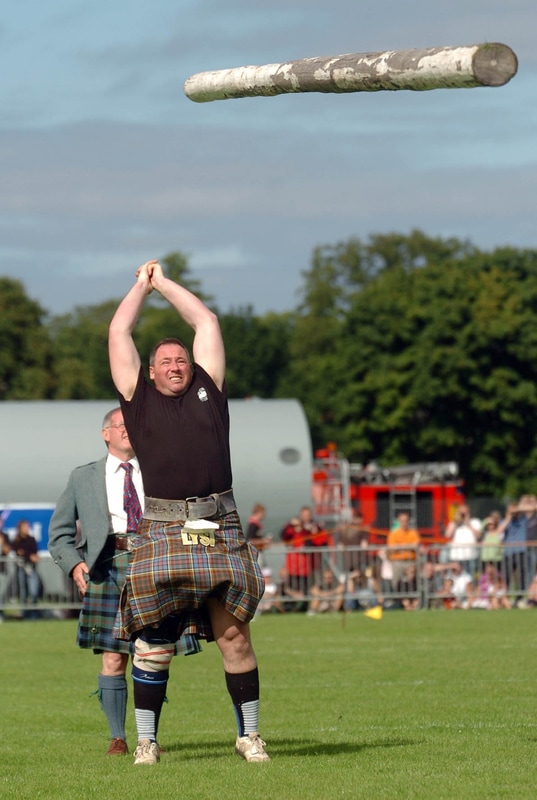 Picture of man tossing a caber